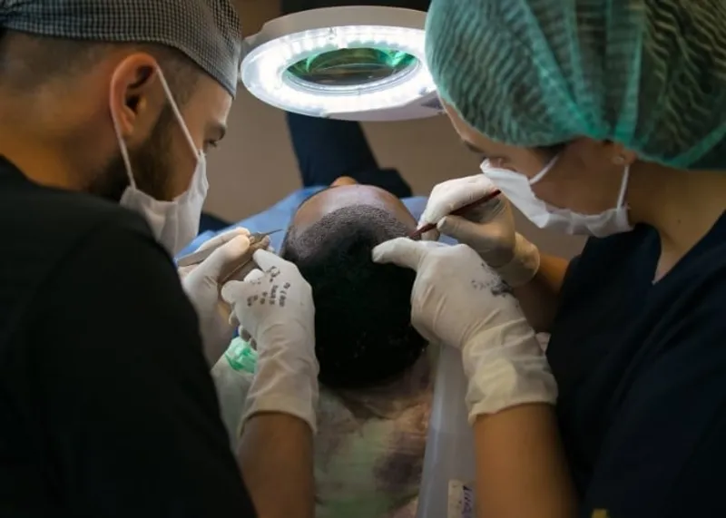 Specialist consulting a patient at an Istanbul hair restoration clinic, where photos are shared only with consent