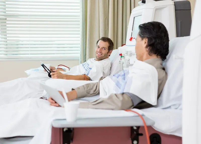 A doctor prepares follow-up notes and reports for a patient at a hospital workstation.