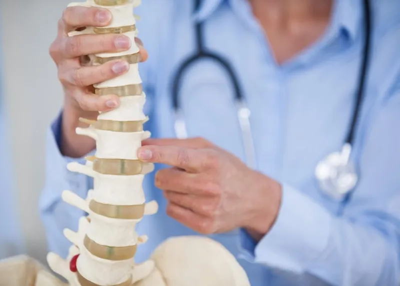 A clinician discusses recovery goals with a patient in a modern treatment room.