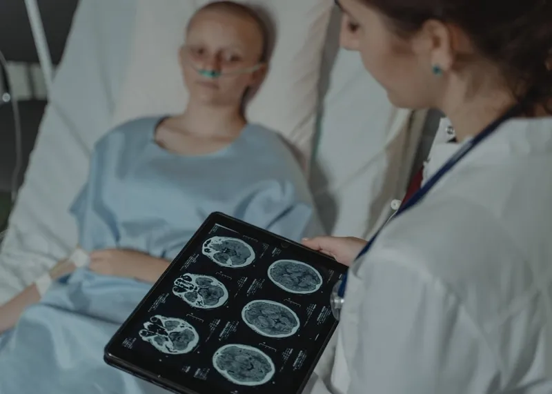 A specialist in a white coat talks a patient through the next steps of their care.