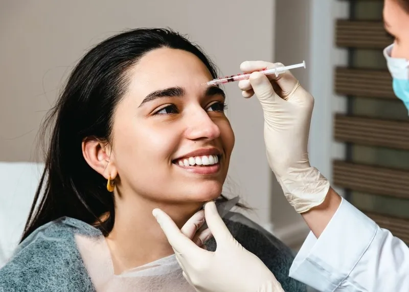 A practitioner prepares a Botox injection for a patient at a cosmetic clinic in Istanbul.