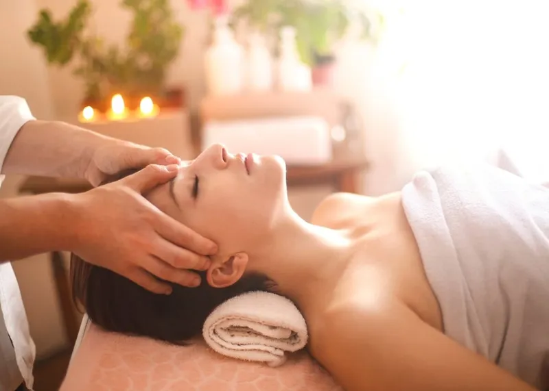 Massage therapist working with a guest in a calm spa treatment room in Istanbul