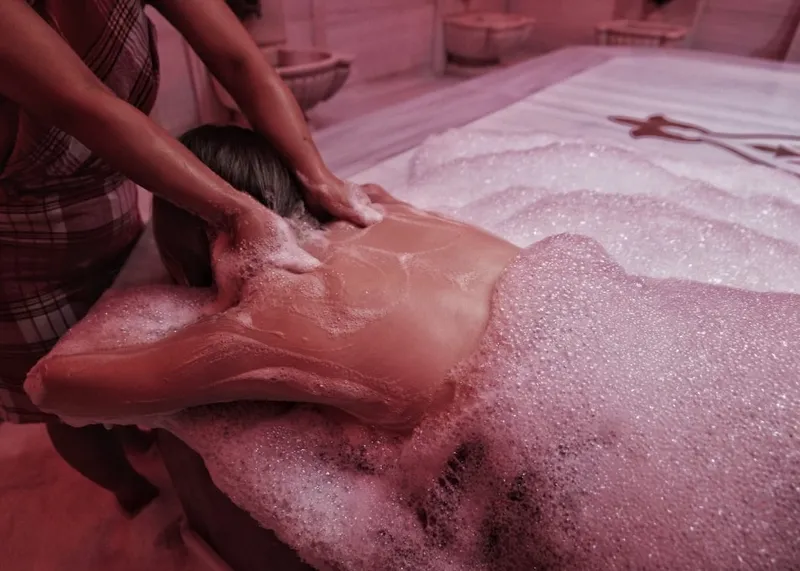Steam rising over the warm marble bathing platform of a traditional Istanbul hammam