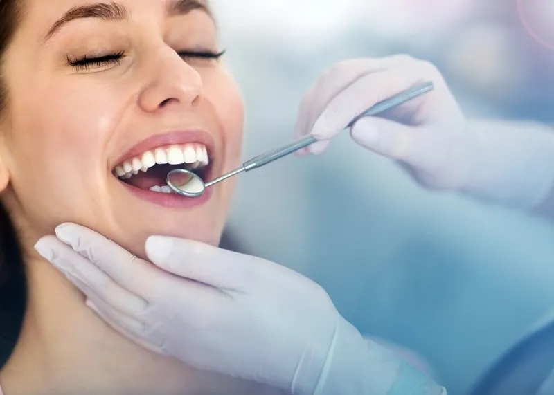 Dentist examining a patient's teeth during a check-up at Medialkent