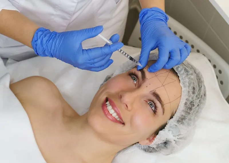 Specialist consulting a patient about facial cosmetic procedures at an Istanbul clinic